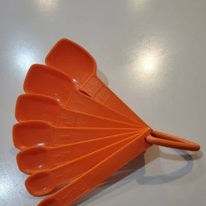 Vintage Tupperware Orange measuring spoons 7 piece set with ring.